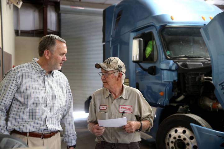 Paul Truman, owner of Truline Corporation, talks to mechanic Pete Schladweiler at his trucking ...