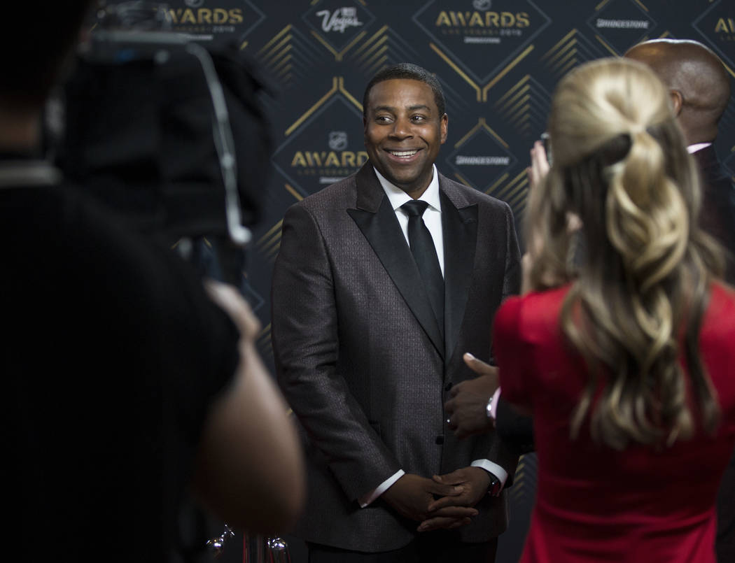 NHL Awards host Kenan Thompson, middle, talks with media on the red carpet before the start of ...
