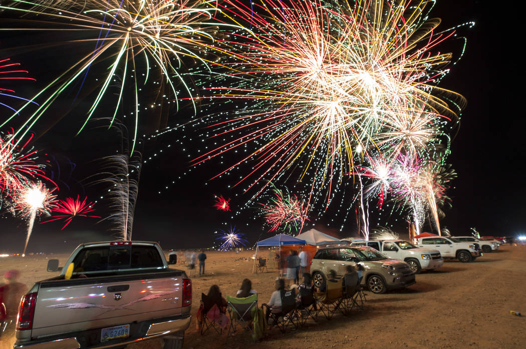 Fireworks explode from a launchpad behind the Moapa Paiute Travel Plaza fireworks store during ...