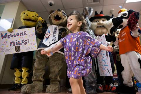 Camila Silva, 2, dances with a group of Las Vegas-based mascots during a welcome event for Mile ...