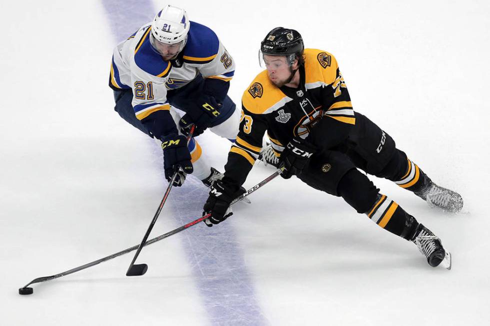 St. Louis Blues' Tyler Bozak, left, defends against Boston Bruins' Charlie McAvoy during the se ...