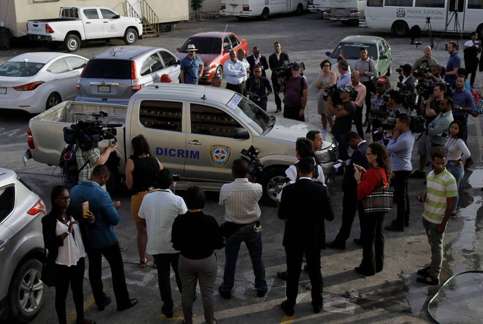 Journalists surround the police vehicle carrying Eddy Vladimir Féliz Garcia who was taken ...