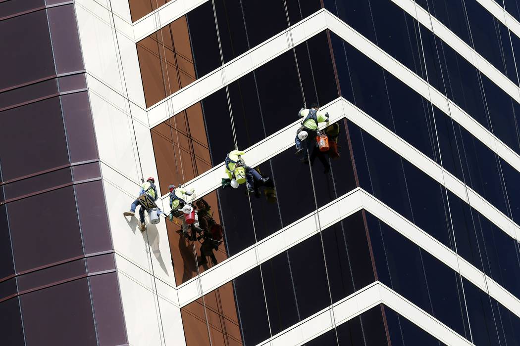Window washers work on Encore Boston Harbor in Everett, Mass., Wednesday, May 22, 2019. MGM Res ...