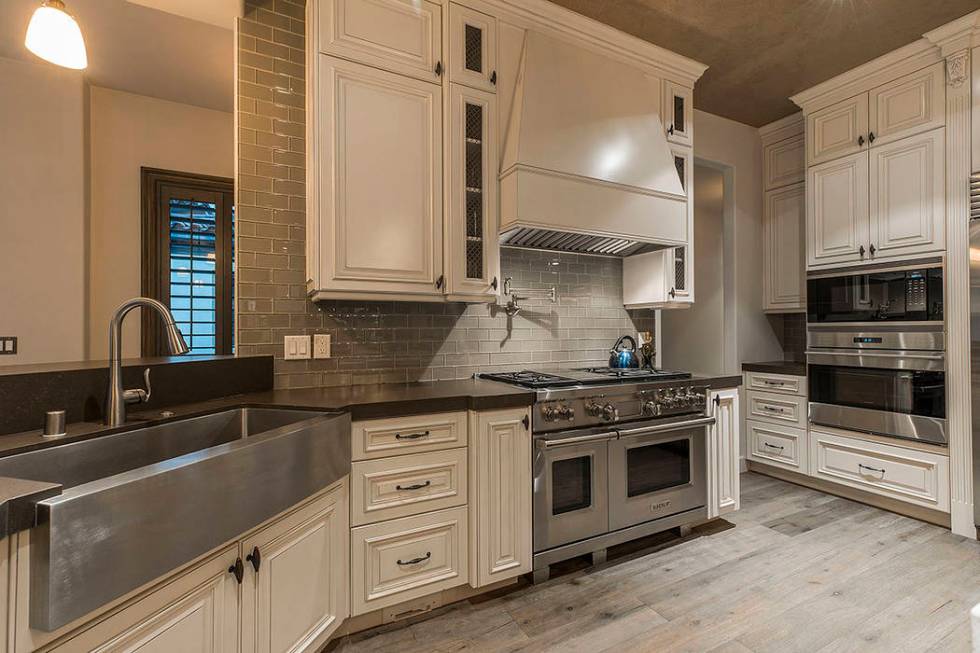 The kitchen features stainless steel appliances and a large farmers sink. (Ivan Sher Group)
