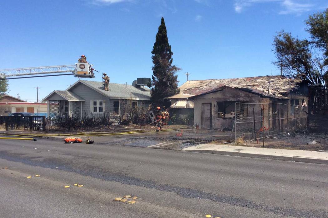 Two houses were damaged in a fire that started in another house in the 2100 block of East Stewa ...