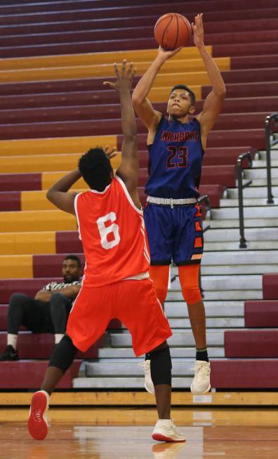 Las Vegas Knicks guard Nick Blake (23) takes a shot during his basketball game at Del Sol Acade ...