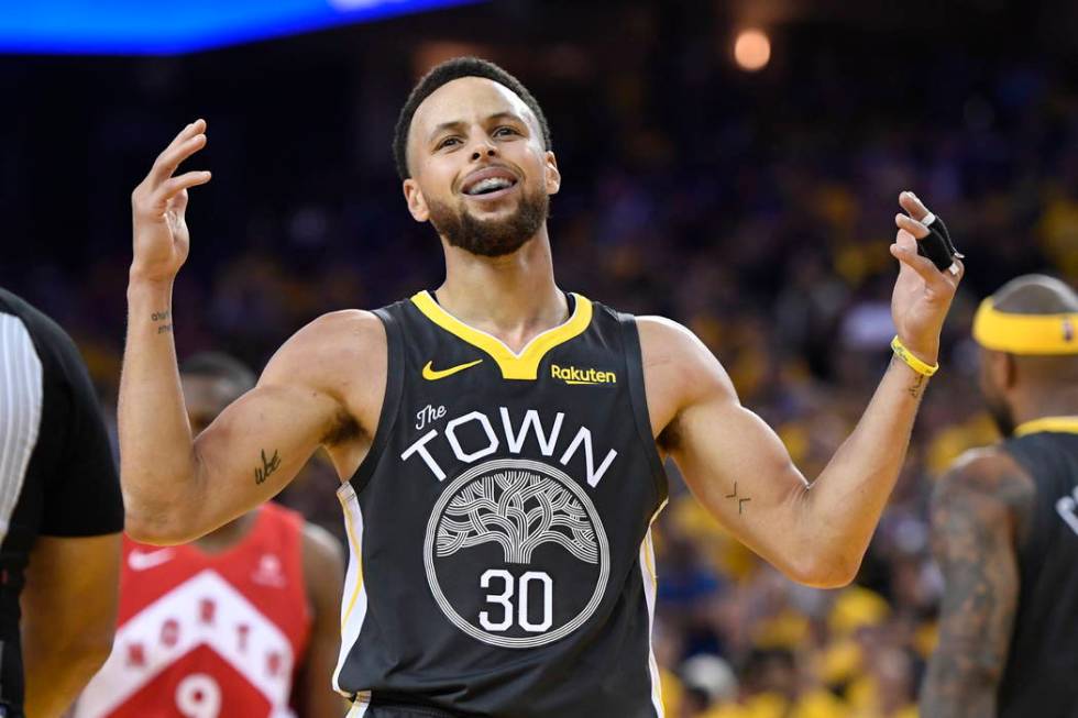 Golden State Warriors guard Stephen Curry reacts after teammate Klay Thompson was injured durin ...