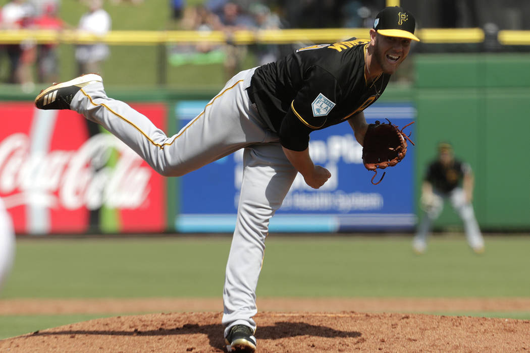 Pittsburgh Pirates starting pitcher Nick Kingham follows through on a delivery in the second in ...