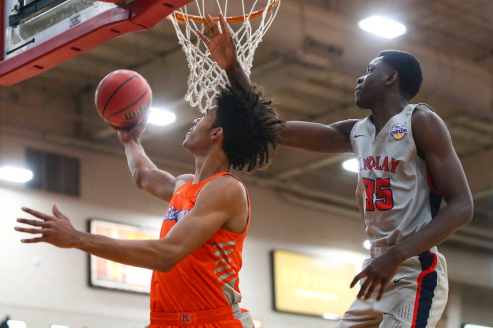 Bishop Gorman's Isaiah Cottrell goes to the basket in front of Findlay Prep's Alex Tchikou (35) ...