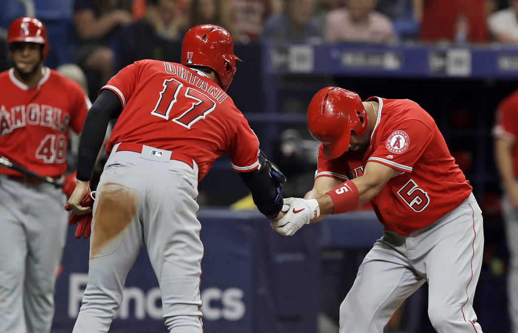 Los Angeles Angels' Albert Pujols (5) bows as he shakes hands with Shohei Ohtani (17), of Japan ...