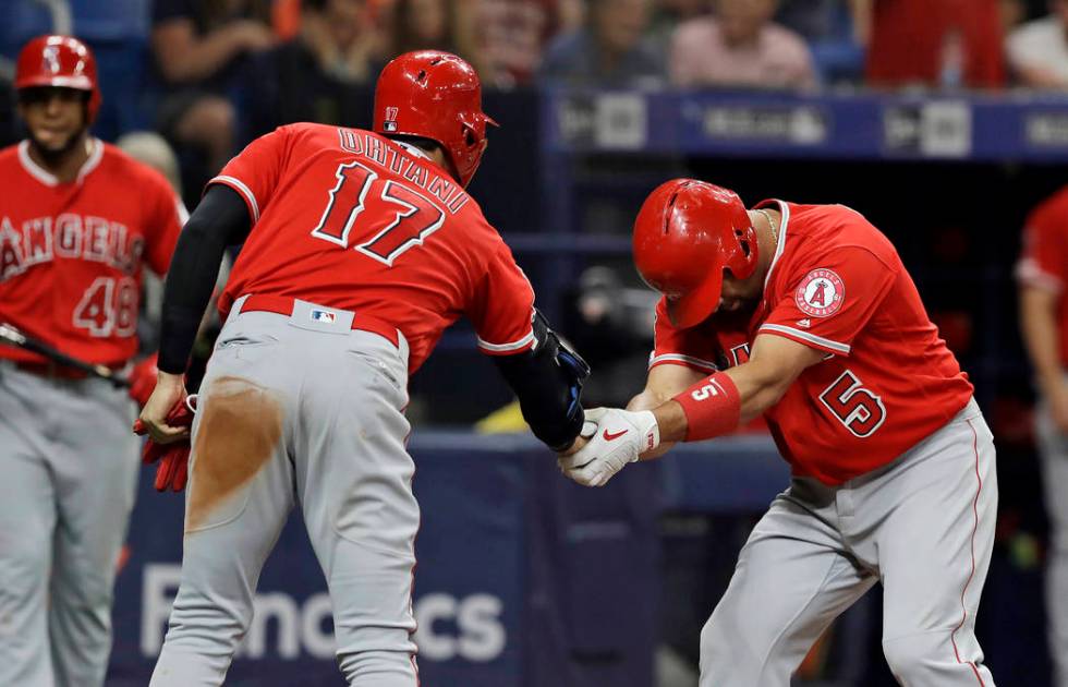Los Angeles Angels' Albert Pujols (5) bows as he shakes hands with Shohei Ohtani (17), of Japan ...