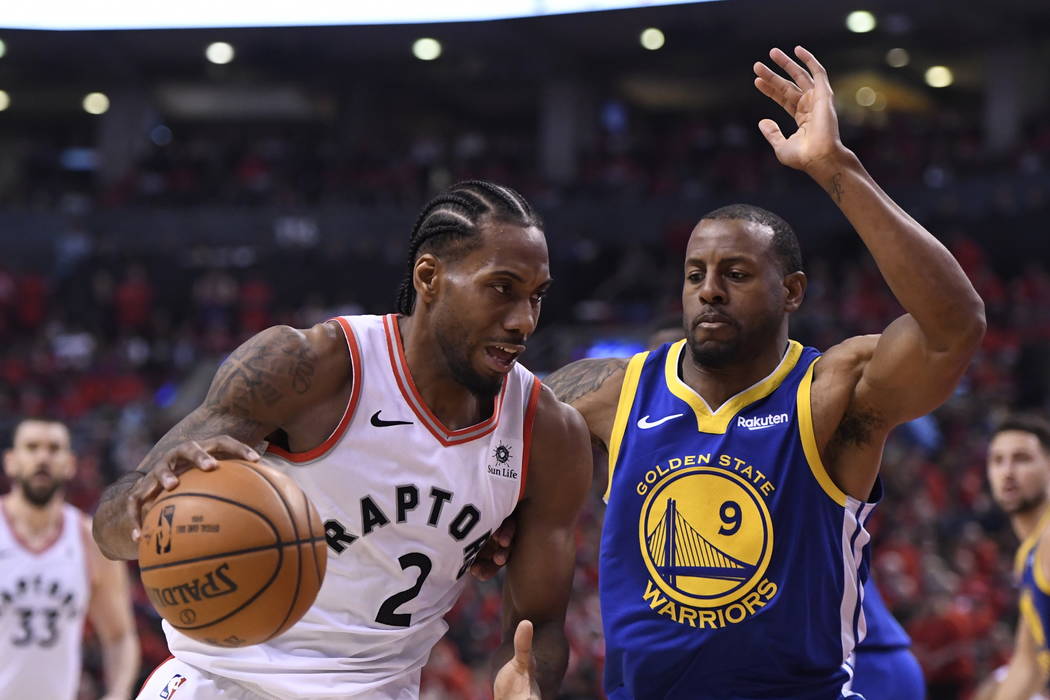 Toronto Raptors forward Kawhi Leonard (2) drives against Golden State Warriors forward Andre Ig ...