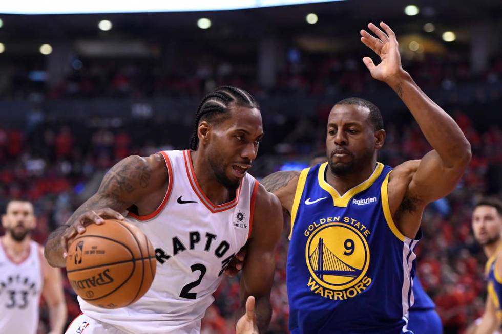 Toronto Raptors forward Kawhi Leonard (2) drives against Golden State Warriors forward Andre Ig ...