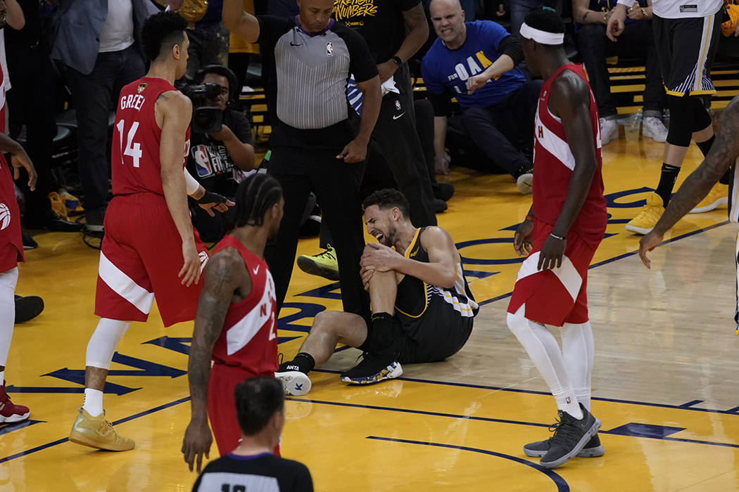 Golden State Warriors guard Klay Thompson reacts after being injured during the second half of ...