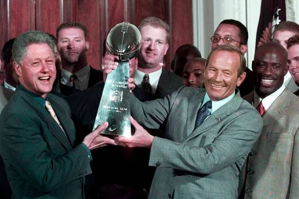 In a June 16, 1998, file photo, then President Clinton, left, and Denver Broncos owner Pat Bowl ...