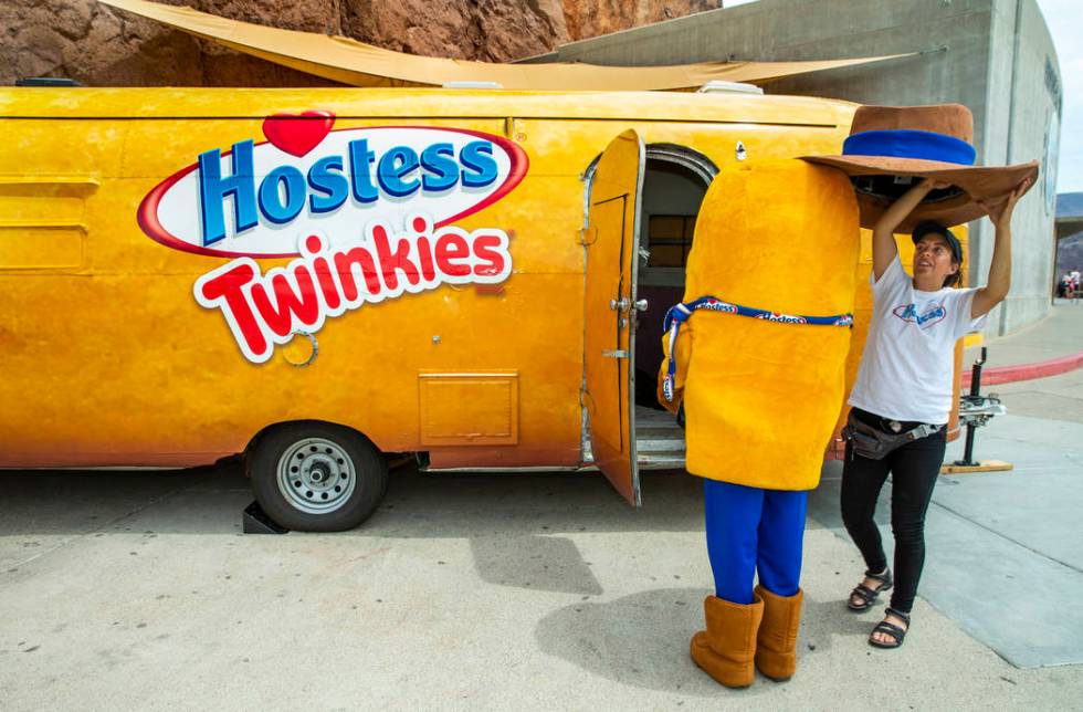 Twinkie the Kid has their hat removed by Katie Lewis while on a stop at the Hoover Dam in celeb ...