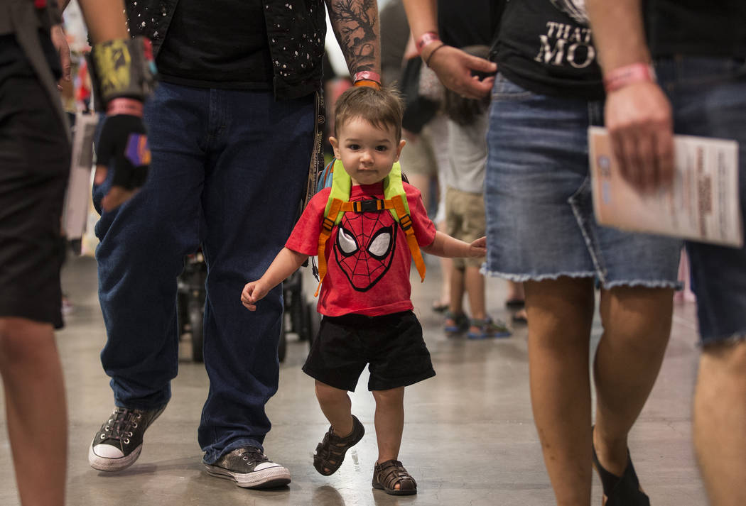 Flynn Rickenbaugh, 2, walks the North Halls with his family during the Amazing Las Vegas Comic ...