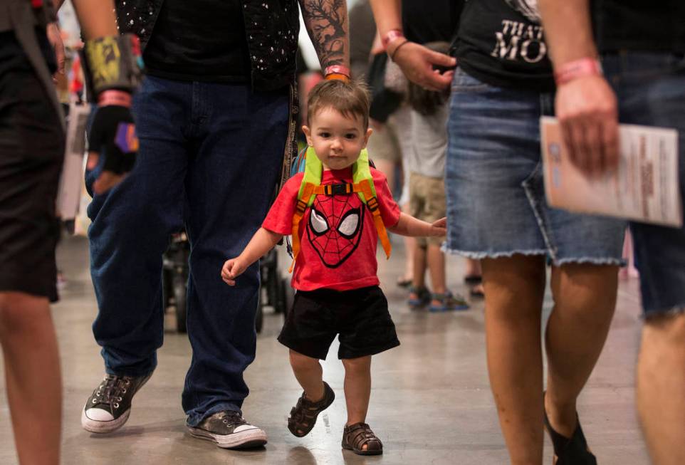Flynn Rickenbaugh, 2, walks the North Halls with his family during the Amazing Las Vegas Comic ...