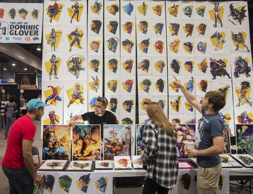 Artist Dominic Glover, second from left, talks with comic fans during the Amazing Las Vegas Com ...