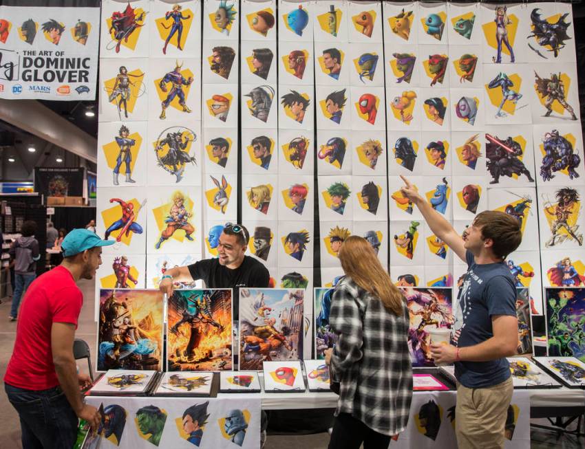 Artist Dominic Glover, second from left, talks with comic fans during the Amazing Las Vegas Com ...