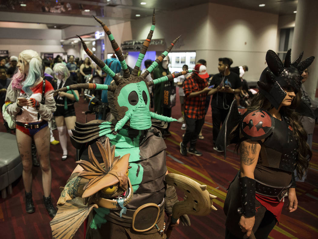 Robin Hampton, left, dressed as a character in "How to Train Your Dragon," waits in line to ent ...