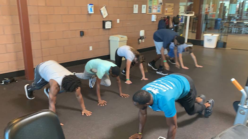 Courtney Woods does push ups alongside teens participating in his Power Hour class at the SkyVi ...