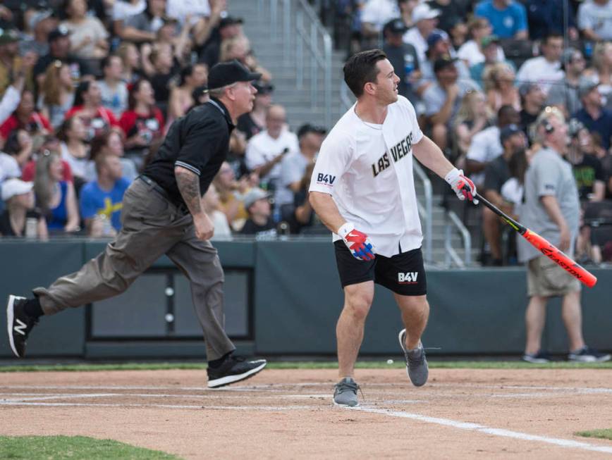 Golden Knights center Jonathan Marchessault, right, watches his ball sail over the left field w ...