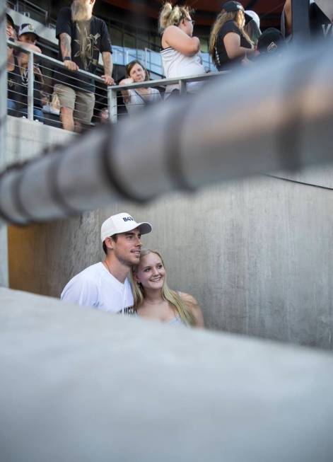 Golden Knights right wing Reilly Smith, left, takes a photo with Grace Jacobson before the star ...