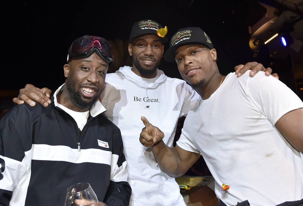 LAS VEGAS, NEVADA - JUNE 14: Kawhi Leonard (C) and Kyle Lowry (R) of the Toronto Raptors celeb ...