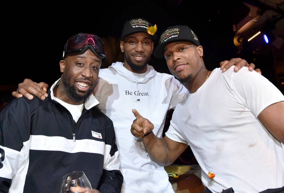 LAS VEGAS, NEVADA - JUNE 14: Kawhi Leonard (C) and Kyle Lowry (R) of the Toronto Raptors celeb ...