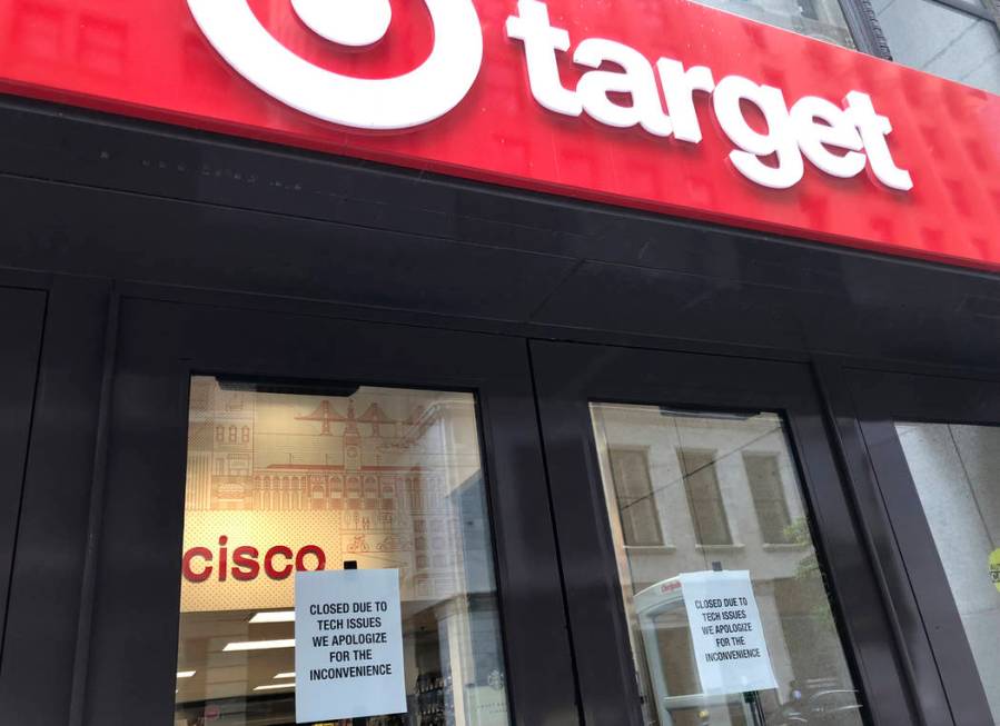 A sign is posted explaining a technical glitch at a Target store in San Francisco on Saturday, ...