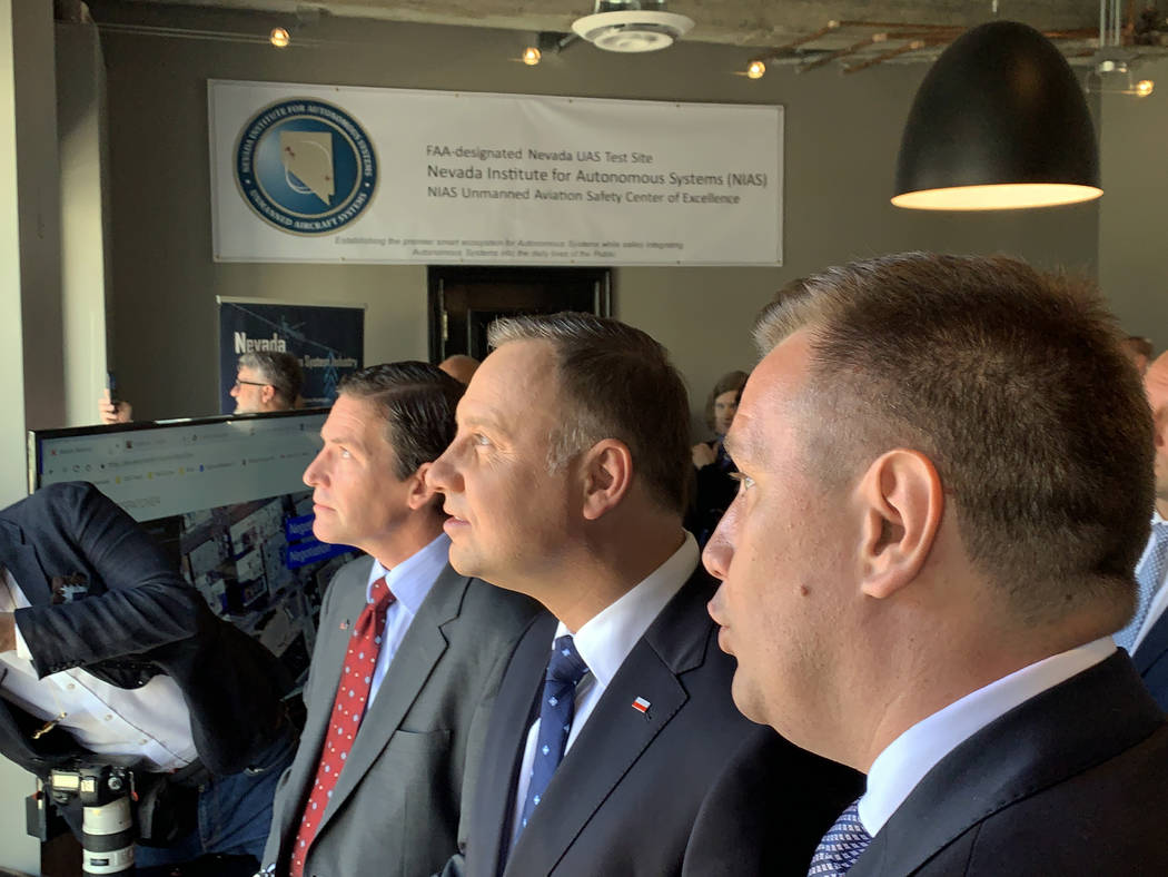 President of Poland Andrzej Duda watches a demonstration of a drone deploying in an urban envir ...