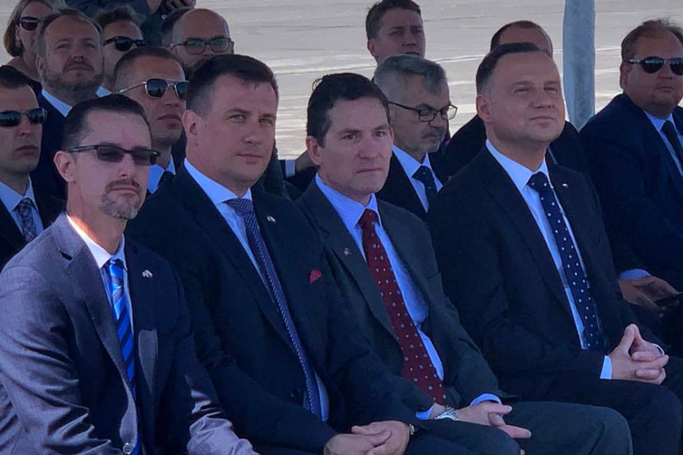 President of Poland Andrzej Duda and others await the landing of a drone at the Reno-Stead Airp ...