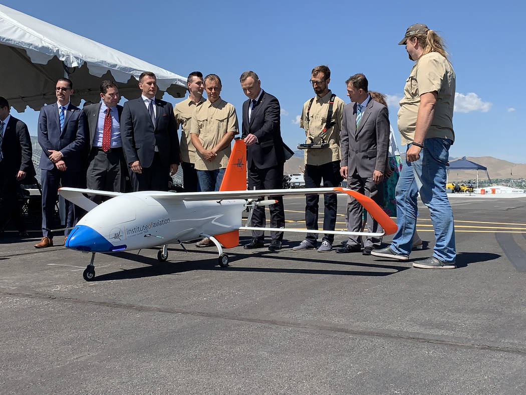 President of Poland Andrzej Duda poses for photos with the drone team at the Reno-Stead Airport ...