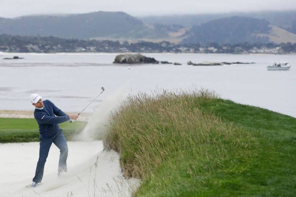 Justin Rose, of England, hits out of the bunker on the 18th hole during the third round of the ...