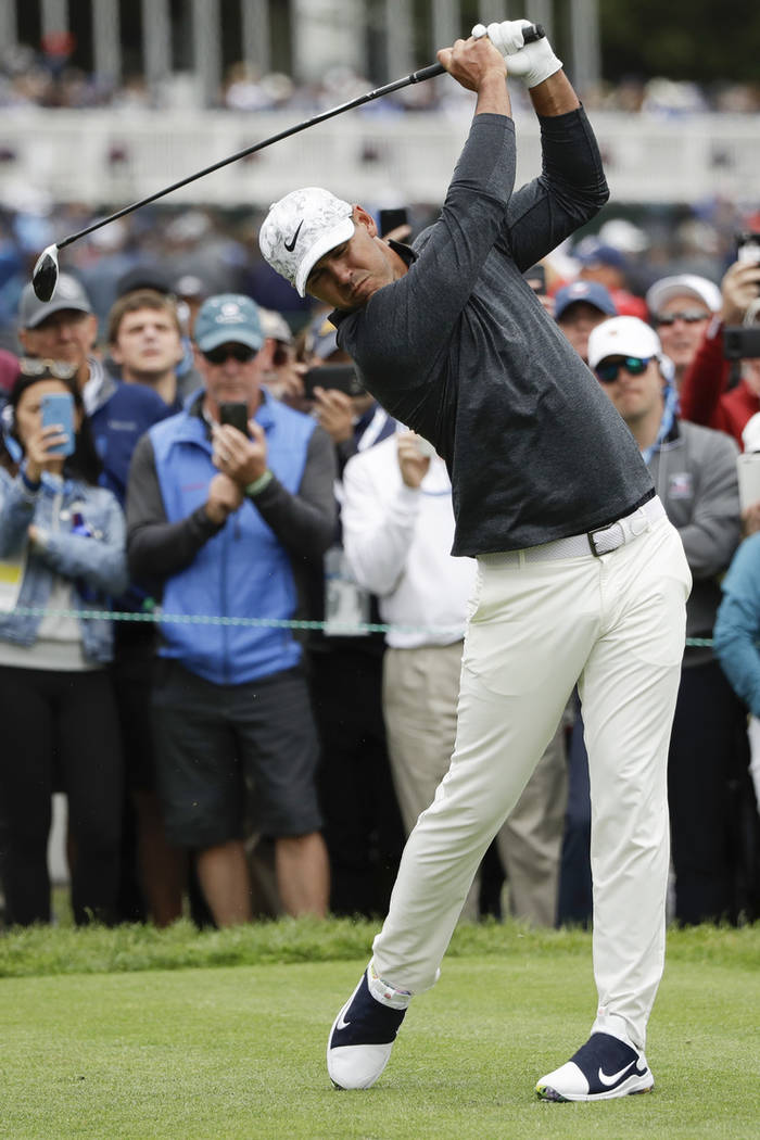 Brooks Koepka hits his tee shot on the third hole during the third round of the U.S. Open Champ ...