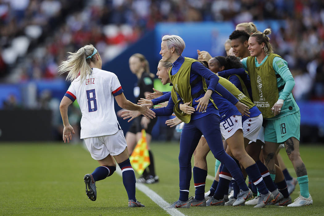 United States' Julie Ertz, left, celebrates with teammates after scoring their second goal duri ...
