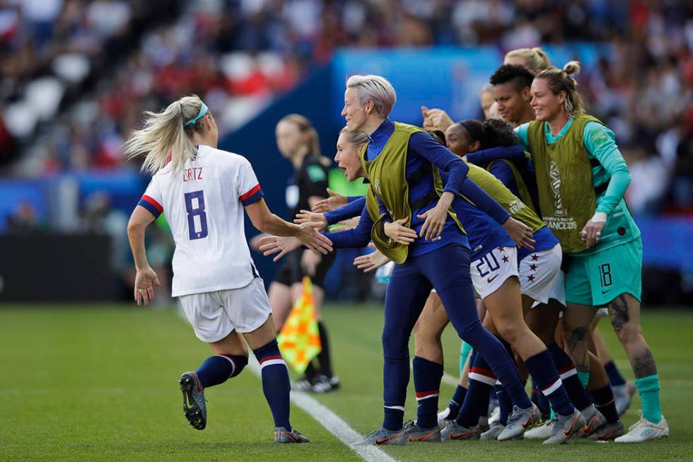 United States' Julie Ertz, left, celebrates with teammates after scoring their second goal duri ...
