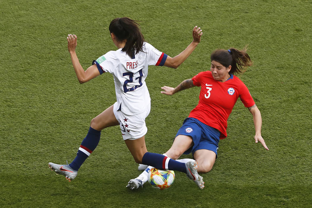 Chile's Carla Guerrero tackles United States' Christen Press, left, during the Women's World Cu ...
