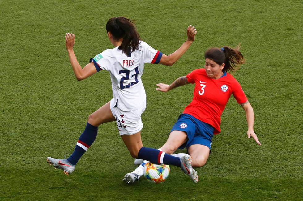 Chile's Carla Guerrero tackles United States' Christen Press, left, during the Women's World Cu ...