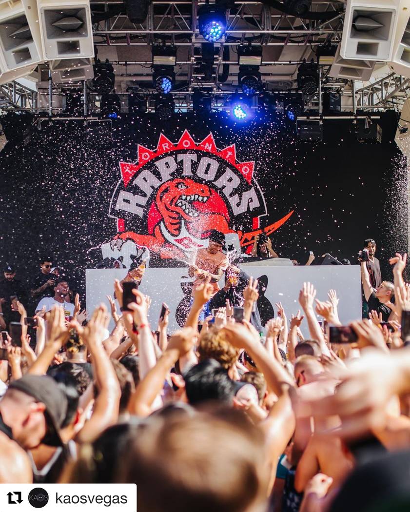 Members of the Toronto Raptors spray champagne on the crows at Kaos Dayclub at the Palms on Sat ...