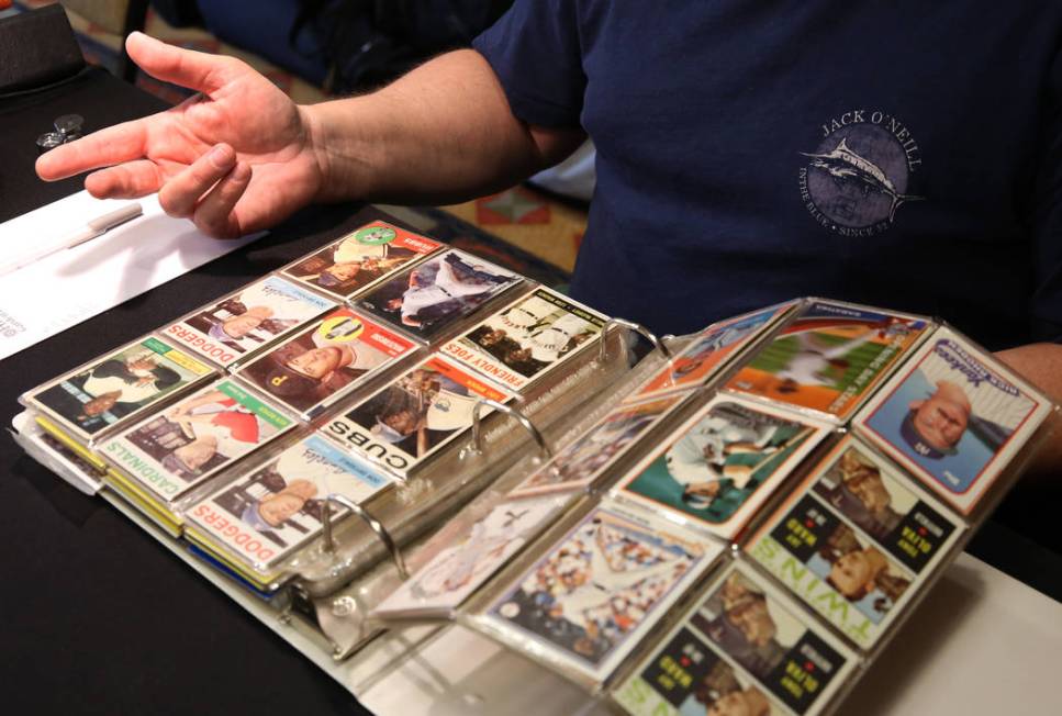 Brian Marcy, owner of Scottsdale Baseball Cards, inspects valuable sports cards on Friday, Jun ...