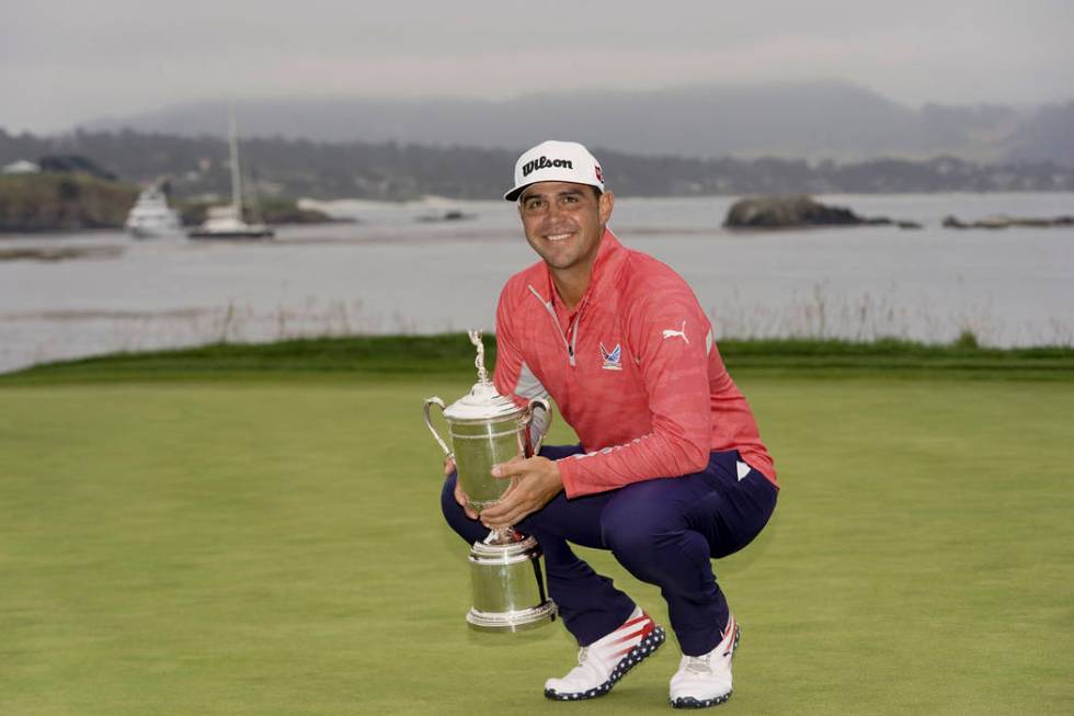 Gary Woodland posses with the trophy after winning the U.S. Open Championship golf tournament S ...