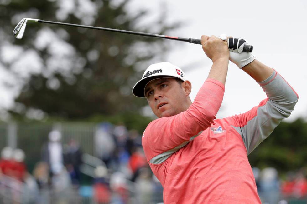 Gary Woodland watches his tee shot on the fourth hole during the final round of the U.S. Open C ...