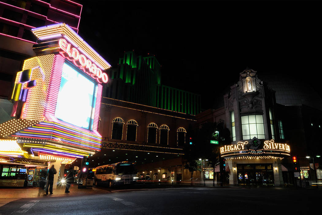 Pedestrians wait to cross the street from the Eldorado Hotel and Casino to the Silver Legacy Re ...