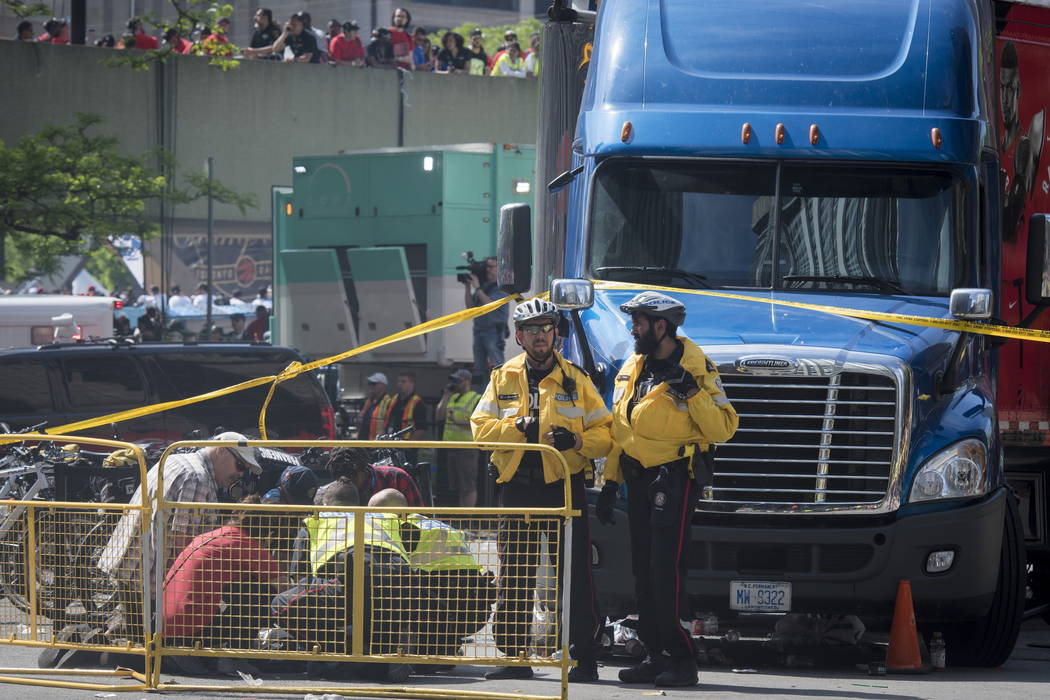 First responders attend to an injured person after shots were fired during the Toronto Raptors ...