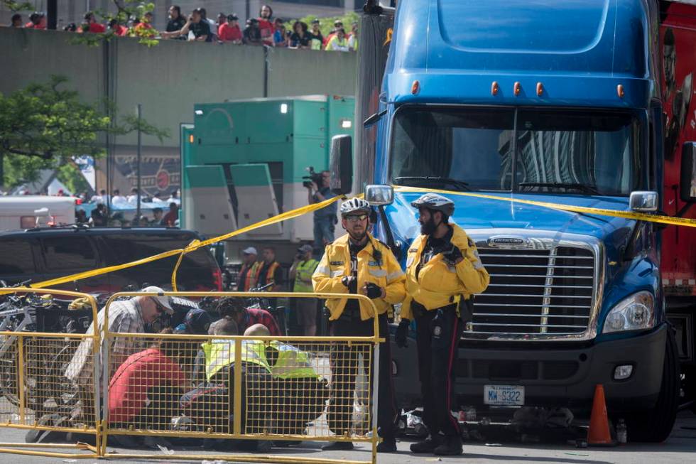 First responders attend to an injured person after shots were fired during the Toronto Raptors ...