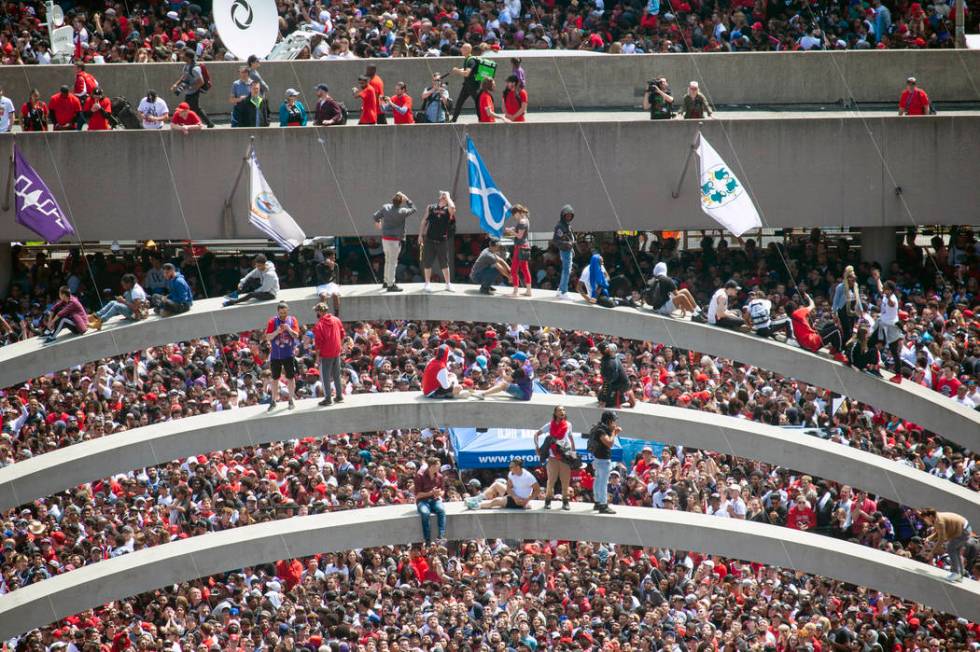 Fans climb the arches at Nathan Phillips Square ahead of the 2019 Toronto Raptors NBA basketbal ...