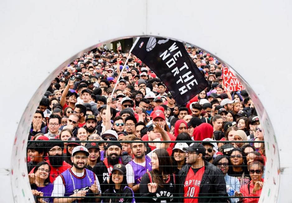 Thousands of fans gather to cheers on the Toronto Raptors during the NBA basketball team's cham ...