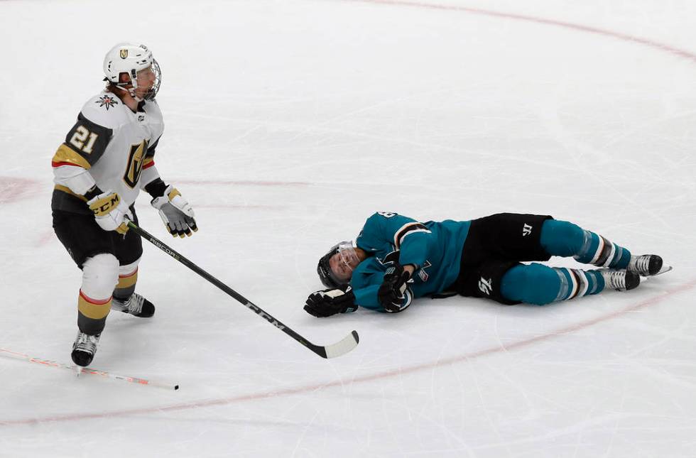 San Jose Sharks center Joe Pavelski, right, lies on the ice next to Vegas Golden Knights center ...